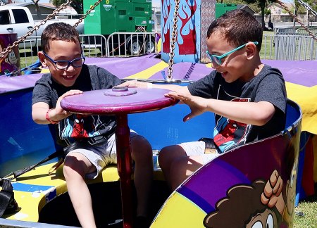Evan and Owen Bunker work the wheel on the Tubs of Fun!